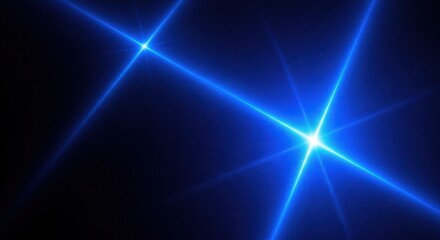 Obraz premium Bright blue lens flares and starburst effects on a dark space background with stars