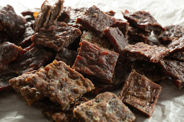 A closeup view of pieces of venison jerky.