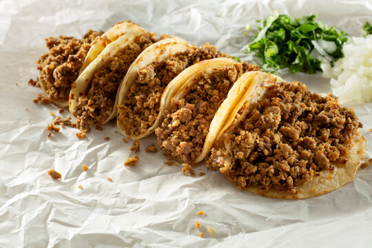 A view of several carne asada tacos.