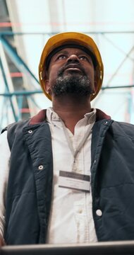 Thinking, distribution and black man in warehouse, planning for stock management and low angle. Safety, mature person and employee in factory, solution or supply chain with trolley and offloading