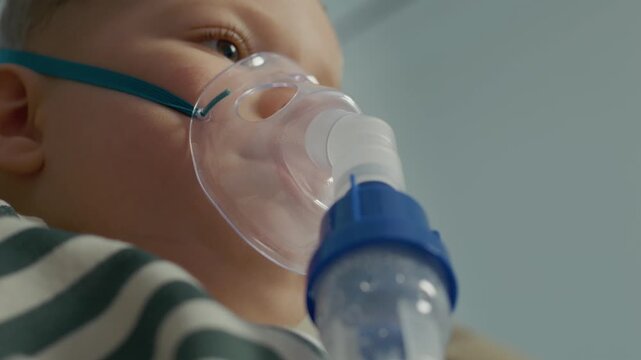 Child is using a nebulizer at home to treat pneumonia caused by polluted air. The method involves steam inhalation for improving lung health.