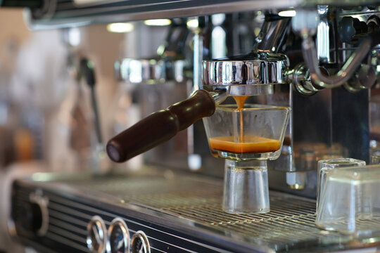 Coffee machine preparing cup of coffee.