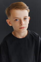 Girl sitting on couch holding small gift in front of Christmas tree