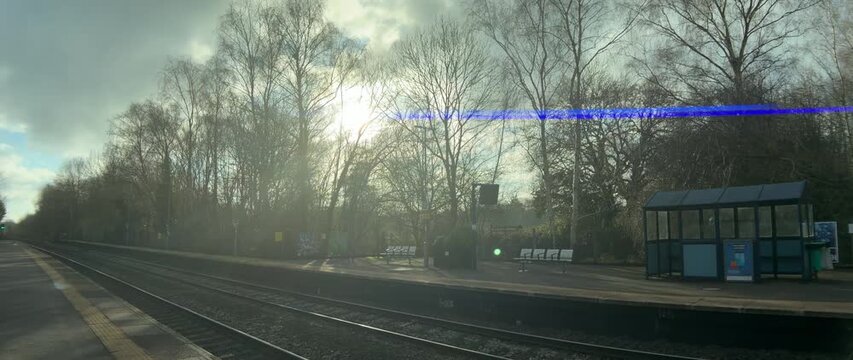 english suburban commuter passenger railway station lapworth solihull england midlands uk. shot with an anamorphic lens., showing characteristic blue flares