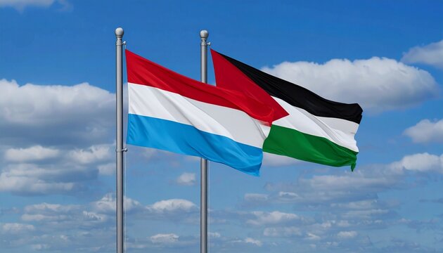 Palestine and Luxembourg flags hoisted on poles against blue sky with clouds.