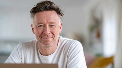 Obraz premium Smiling caucasian mature male in casual white shirt indoors