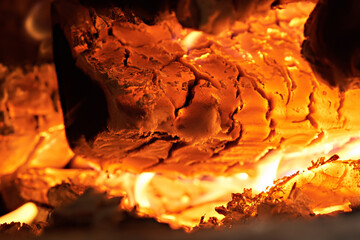 Homemade warm orange campfire with pieces of firewood. Burning firewood in the stove, coal, hot coals,