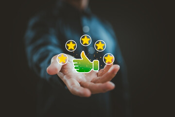 Businessman holding five star rating with thumbs up icon for customer review and positive feedback