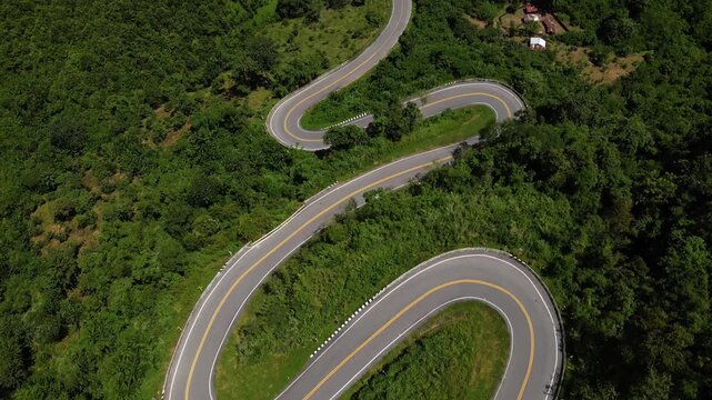 Serene Travel Journey Breathtaking Aerial View of Winding Road Through Thailands Lush Mountain Forest, Scenic and Natural Environment Adventure Awaits
