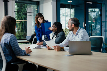 Business professionals discussing project work during meeting