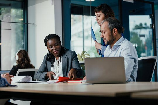 Business colleagues collaborating on project in modern office