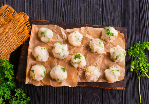 Homemade beef and pork meatballs on baking paper.