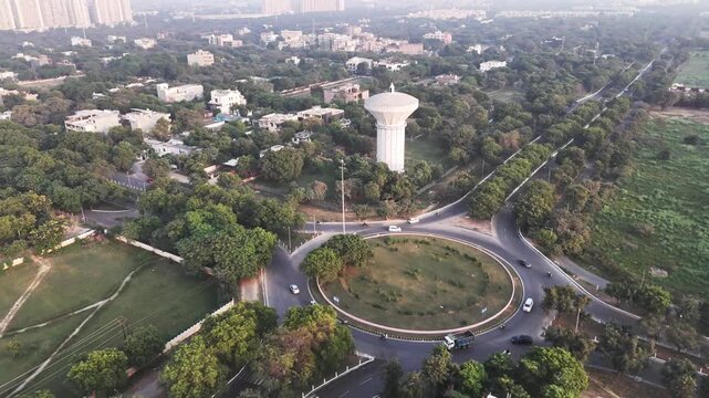 Drone footage of a major Greater Noida junction, featuring a circular road design, light traffic, and surrounding greenery that reflects the city&rsquo;s organized layout and modern planning.