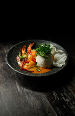 A plate of food with shrimp, rice, and vegetables