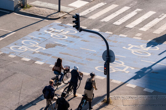 Urban commute traffic at a Copenhagen Denmark intersection shows bicycle cyclist queue on the cycleway highlighting everyday infrastructure and safety