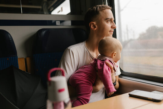 Father and baby traveling by train sharing a family moment