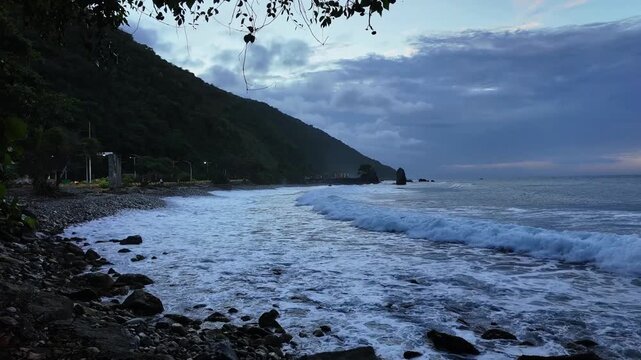 wide shot blue hour magical time over rocky shoreline tropical beach in la Guaira, nature scene bathing the sky intense and deep blue
