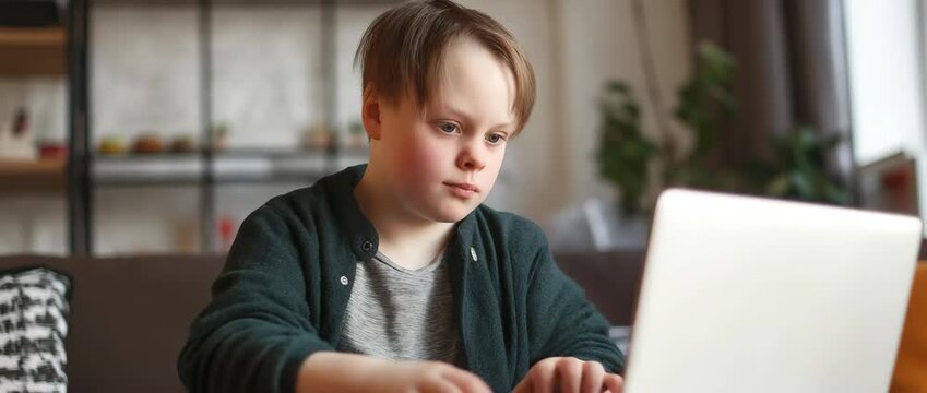 Child with Down syndrome using a laptop at home, education