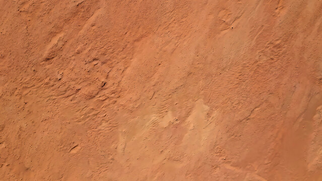 Top-Down Perspective of Natural Sandstone Desert Floor with Wind-Swept Ripples and Earthy Texture
