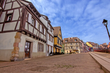 Historic colorful timber houses around a quiet cobblestone square in Colmar.