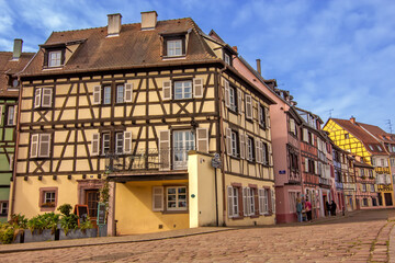 Historic colorful timber houses around a quiet cobblestone square in Colmar.