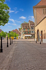 Historic colorful timber houses around a quiet cobblestone square in Colmar.