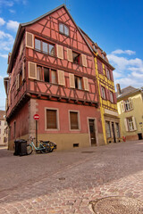 Historic colorful timber houses around a quiet cobblestone square in Colmar.