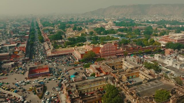 Aerial view of Hawa Mahal's stunning architecture and the bustling streets of Jaipur, with a blend of modern and traditional, Jaipur, Rajasthan, India.
