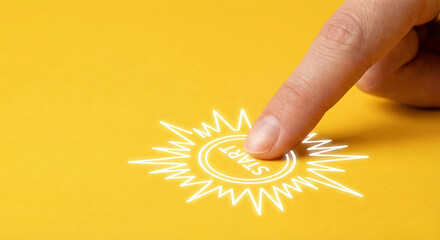 Finger pressing a glowing start button icon on yellow background
