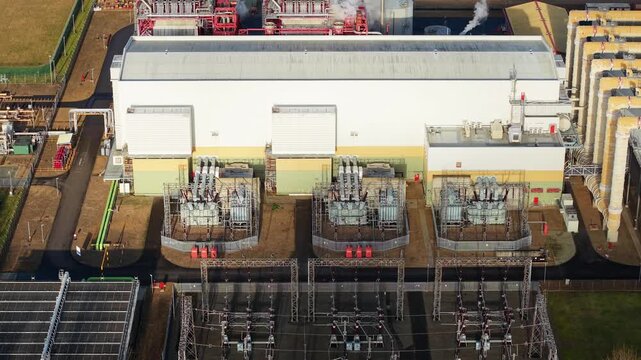 Aerial view of the Sutton Bridge Power Station, a huge industrial building with a white facade and complex piping, Sutton Bridge, United Kingdom.