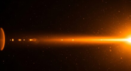 Obraz premium Bright Orange Lens Flare Effect with Floating Particles on Dark Background