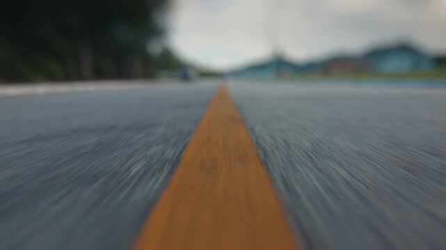 Camera moves fast forward over the asphalt road