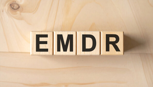 Wooden cubes spelling EMDR, mental health, psychotherapy, Eye Movement Desensitization