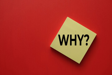 Top view of yellow sticky note with the word Why? on red background with copy space. Asking question, finding reason, critical thinking, problem solving, and urgent demand for answer concept.