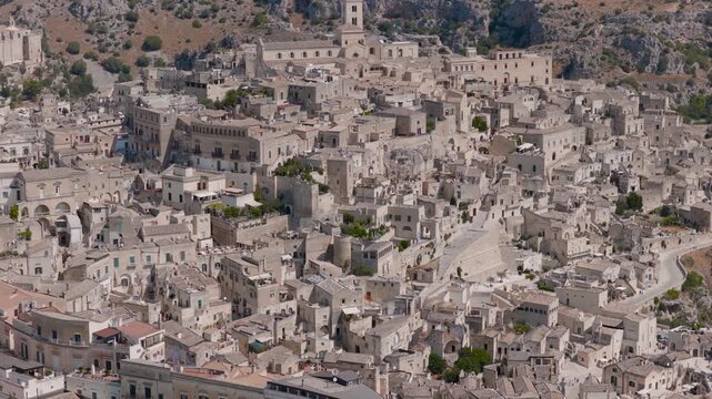 Aerial view of the ancient city showcasing the intricate layout of Matera's Sassi, with its stone buildings blending into the rocky landscape, Matera, Basilicata, Italy.
