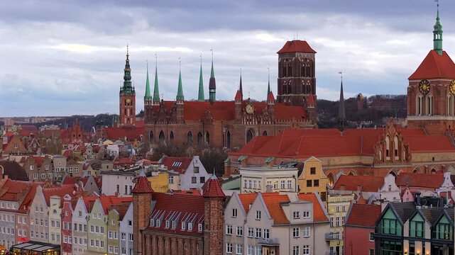 Aerial view of St. Mary's Church's red roofs contrasting with the skyline, creating a vibrant scene, Gdansk, Wojewodztwo pomorskie, Poland.
