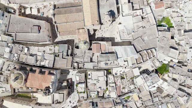 Aerial view of the labyrinthine rooftops and buildings of Ostuni, their textures and hues blending to create a captivating view, Ostuni, Apulia, Italy.