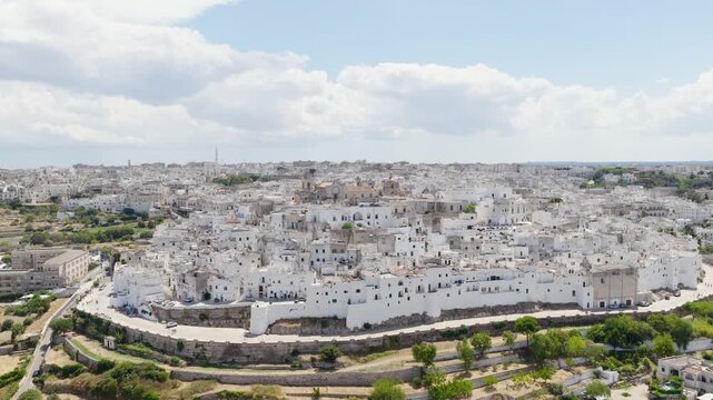 Aerial view of the compact white buildings contrasted against the clear blue sky in Ostuni, Apulia, Italy, creating a mesmerizing scene, Ostuni, Apulia, Italy.