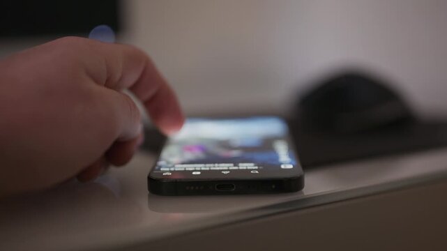 Close up video of a person doom scrolling on social media on a smartphone with content intentionally out of focus, conveying digital addiction technology fatigue and modern screen time behavior for me