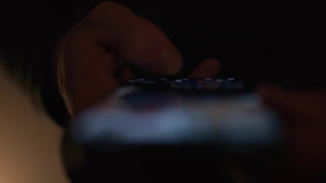 Close up video of a person doom scrolling on social media on a smartphone with content intentionally out of focus, conveying digital addiction technology fatigue and modern screen time behavior for me