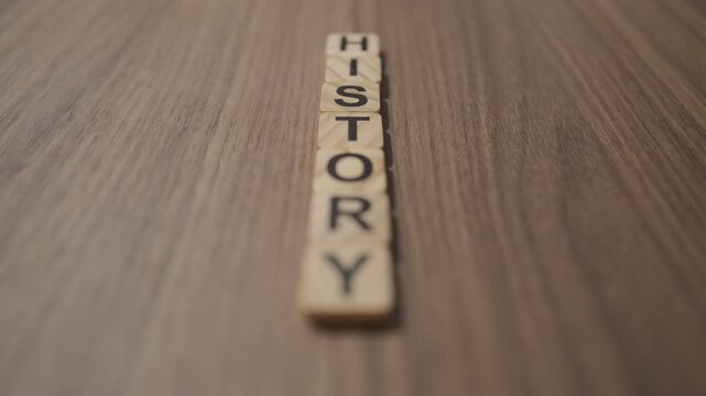 Wooden letters on the table with the word HISTORY written on them
