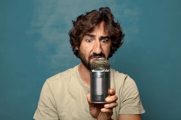 young adult bearded man with a steel open can