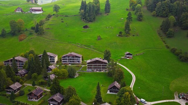 Cinematic drone shot of alpine Swiss village with mountains, 4K