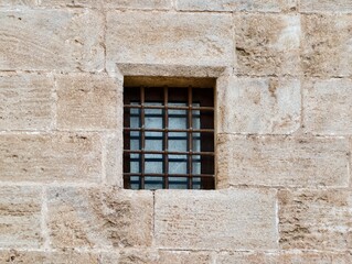 Fototapeta premium Ancient stone window, Historic masonry with niche, Weathered stone wall features small niche window