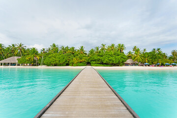Fototapeta premium A wooden jetty in a Beautiful maldives tropical island. copy space.