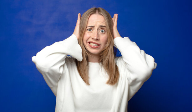 feeling stressed, worried, anxious or scared, with hands on head, panicking at mistake