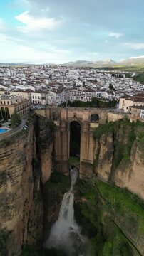 Aerial view of the majestic Puente Nuevo bridge spanning the El Tajo gorge with contrasting textures and tones, Ronda, Andalusia, Spain.