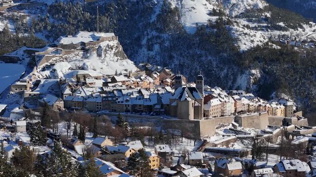 Aerial view of Briancon's snow-dusted roofs and fortress, a striking contrast against the winter landscape, Briancon, Provence-Alpes-Cote d'Azur, France.