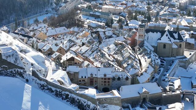 Aerial view of snow covered rooftops and buildings of Briancon, a city nestled within the French Alps, Provence-Alpes-Cote d'Azur, France.
