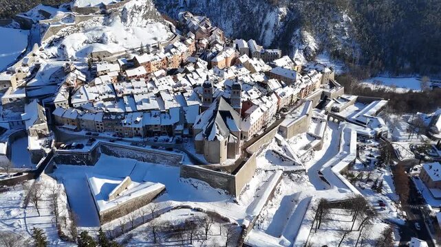 Aerial view of the fortified city of Briancon, a winter wonderland with snow-covered roofs and ramparts, nestled in the French Alps, Briancon, Provence-Alpes-Cote d'Azur, France.